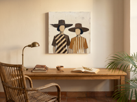 Two Women in Hats Wall Art — Original Palette-Knife Oil, Chocolate & Caramel — original hand-painted oil shown on the wall in a styled room