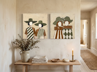 Women in Wide-Brim Hats — Set of 2 Original Oils, Olive & Rust — original hand-painted oil shown on the wall in a styled room