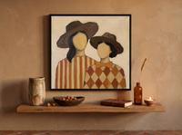 Two Ladies in Wide Hats Wall Art — Original Palette-Knife Oil, Chocolate & Rust — original hand-painted oil shown on the wall in a styled room