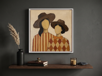 Two Ladies in Wide Hats Wall Art — Original Palette-Knife Oil, Chocolate & Rust — original hand-painted oil shown on the wall in a styled room