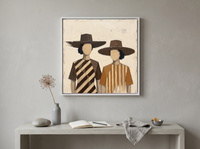 Two Women in Hats Wall Art — Original Palette-Knife Oil, Chocolate & Caramel — original hand-painted oil shown on the wall in a styled room