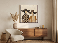 Two Women in Hats Wall Art — Original Palette-Knife Oil, Chocolate & Caramel — original hand-painted oil shown on the wall in a styled room